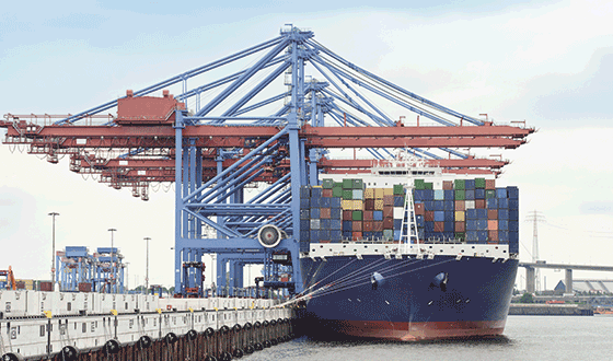 a container ship loaded with containers is unloaded at the port