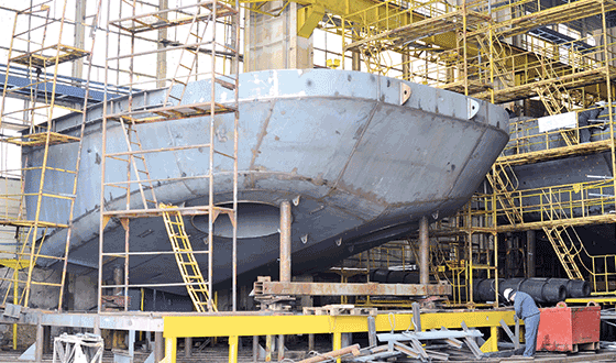 Hull of a ship during construction in a shipyard
